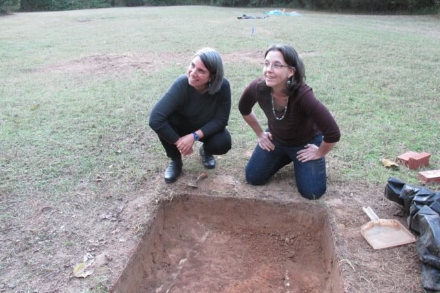 Jillian Galle (left) and Maureen Siewert Meyers check out an excavation unit outside of the Caroline Barr House at Rowan Oak.